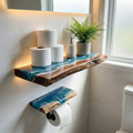 Bathroom shelf with toilet paper, soap dispenser, and plant on a tiled wall.